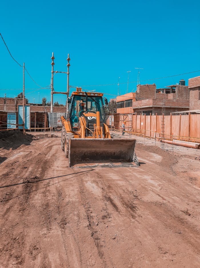 Crafting Captivating Headlines: Your awesome post title goes here Yellow bulldozer on a construction site under clear blue sky, ready for operation.